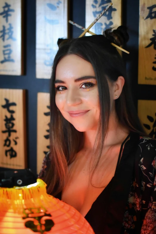 a woman with long hair and wearing paper lanterns