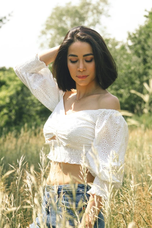 a woman posing for a po in tall grass