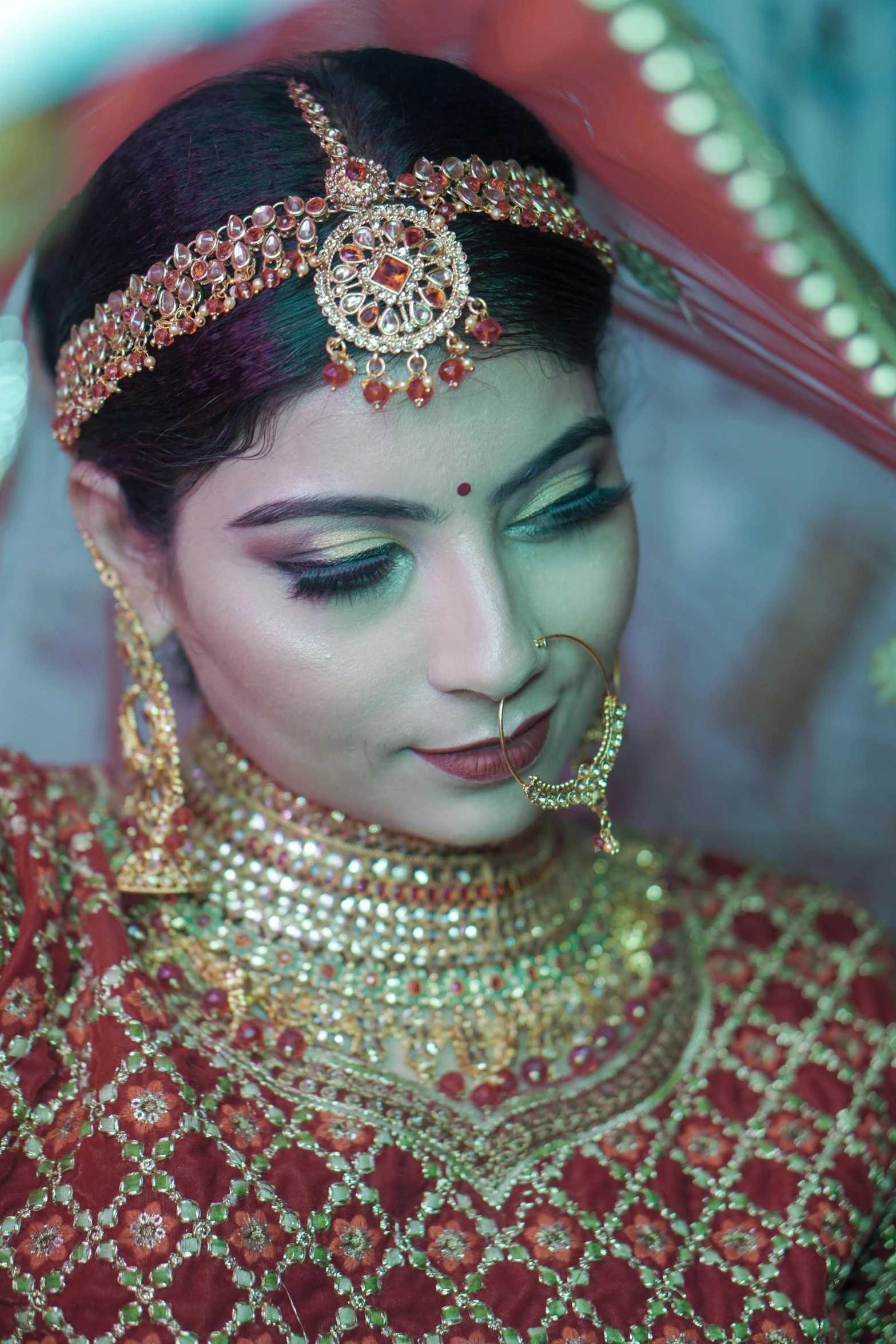 the bridal wears an elaborate necklace and hoop ring