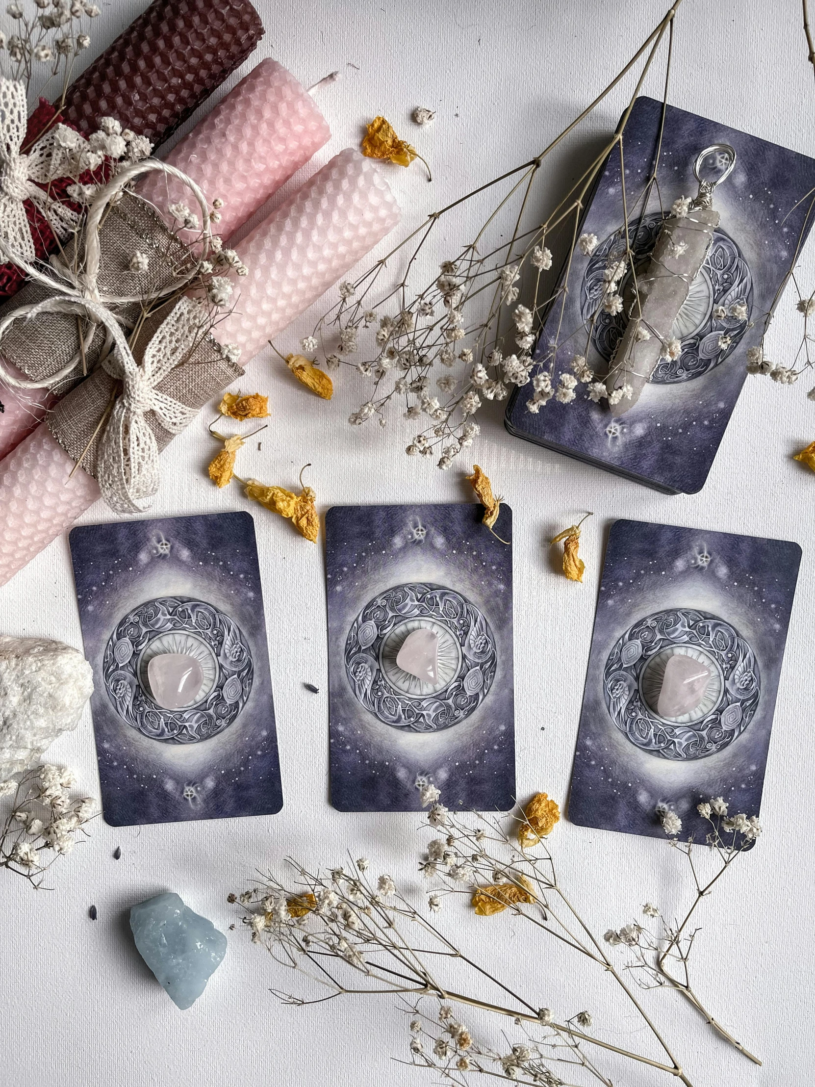 the three cards that are next to the cloths and dried flowers