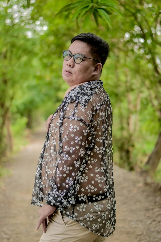 a woman standing in front of some trees