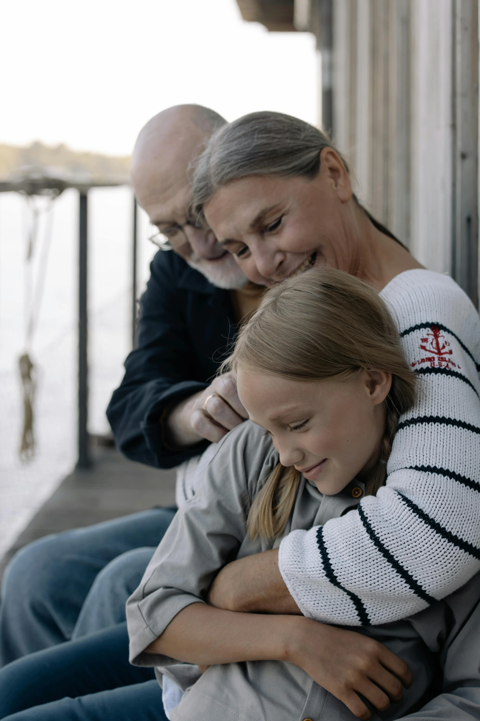 a man and woman emcing on a dock next to each other