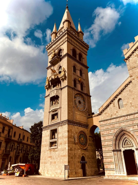 an old tower is in front of buildings