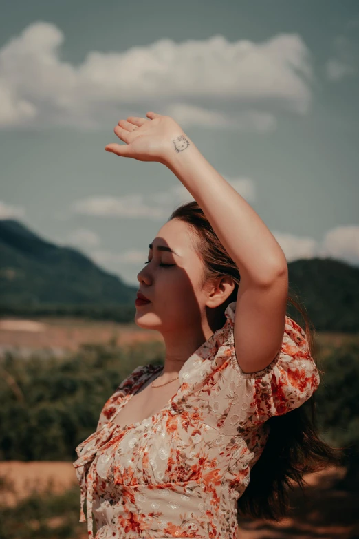 a woman looking upward holding her arms in the air