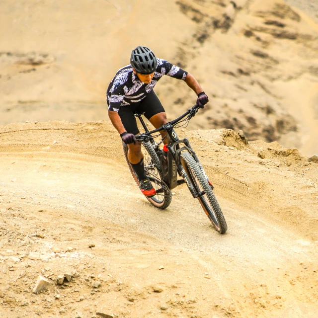 a person riding a mountain bike on a dirt trail