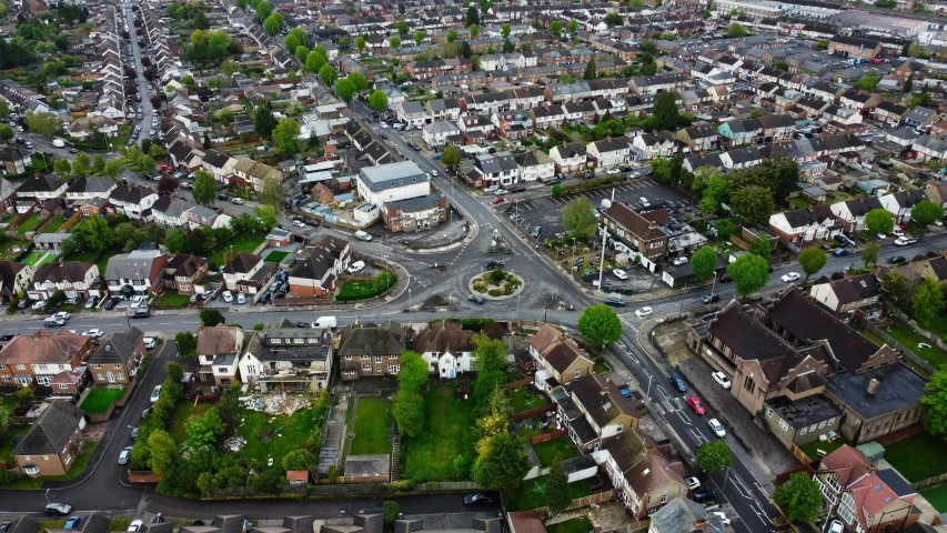 a view from above, of a neighborhood with a long road in the center