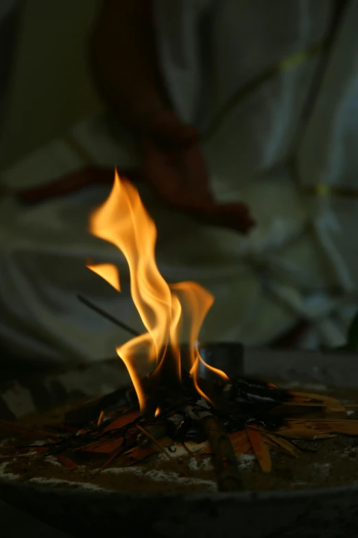 the flames burn from a small fire pit