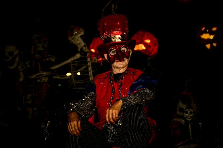 a man dressed up as a magician sitting on a chair