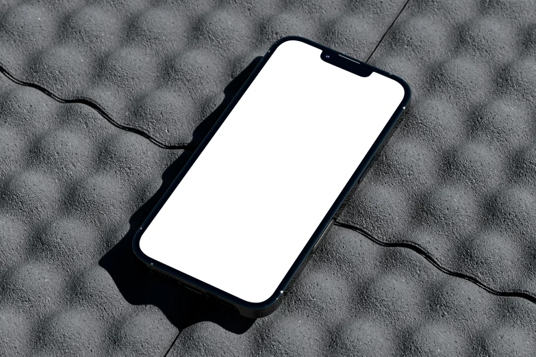 a cellphone on top of a gray surface