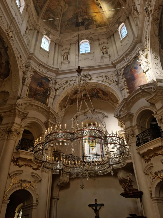 an interior of a cathedral with chandeliers and windows