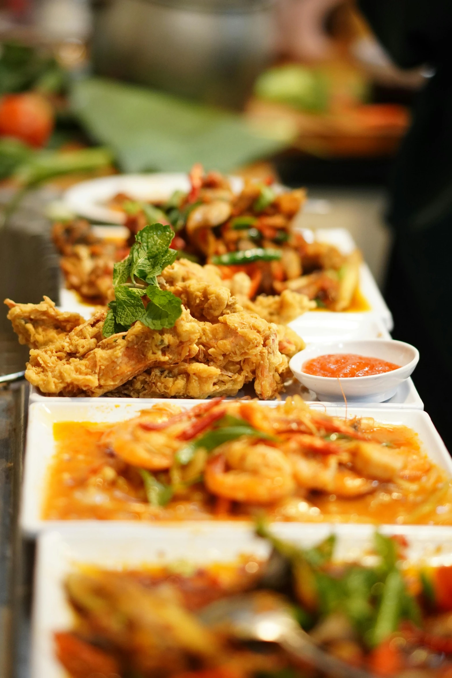 a row of plates filled with different kinds of food