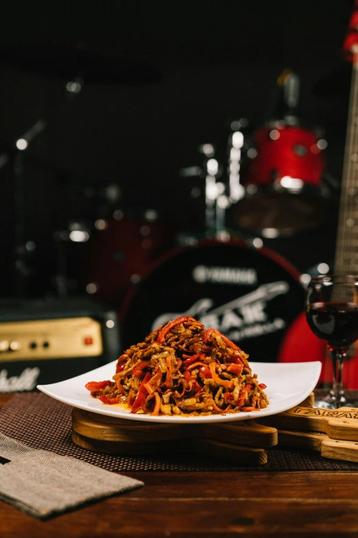 a meal of pasta next to some musical equipment