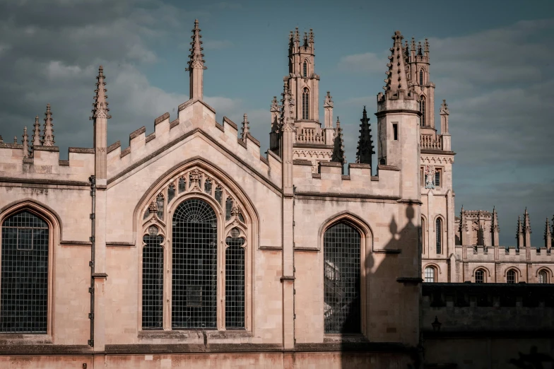 large stone cathedral with two towers under a cloudy sky