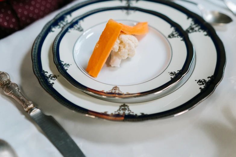 a plate with a small piece of food on it