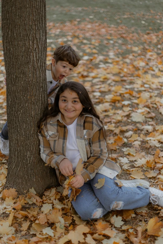 a couple of s sitting next to a tree