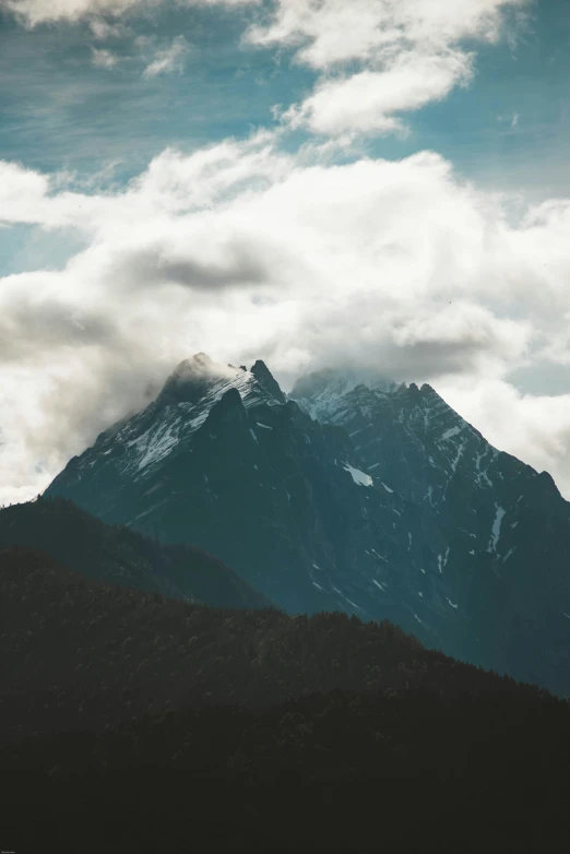 a tall snow covered mountain with a blue sky