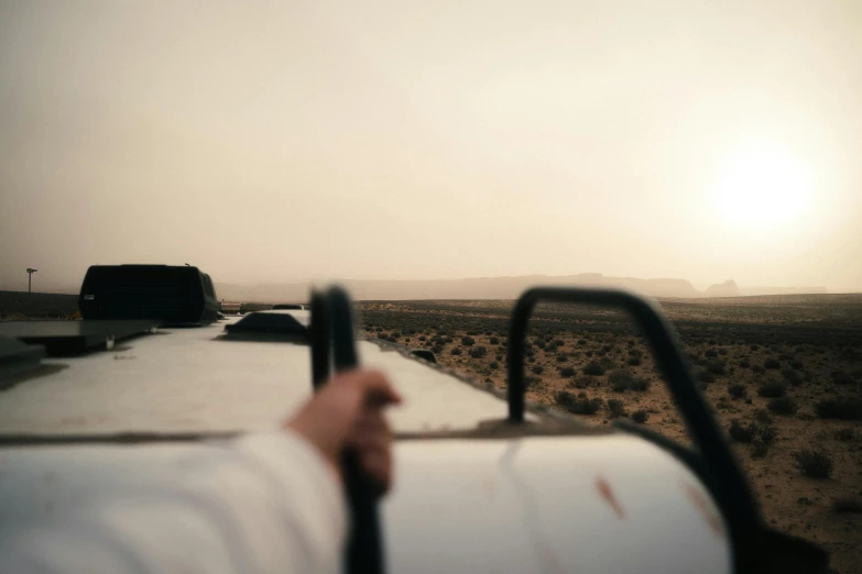 a truck that is in the desert with its bed open