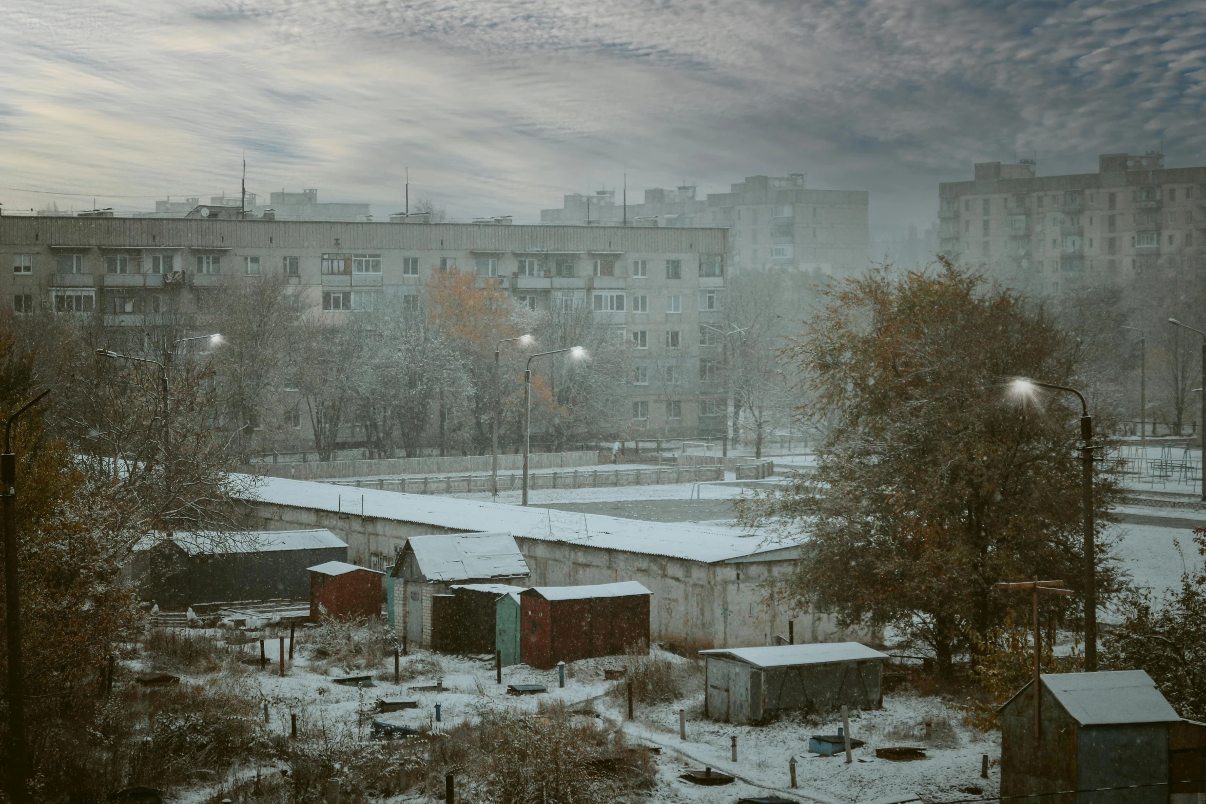 a street scene with the cloudy sky and snowy buildings