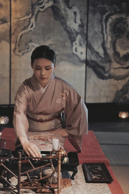 a woman in kimono holding out soing on a rug