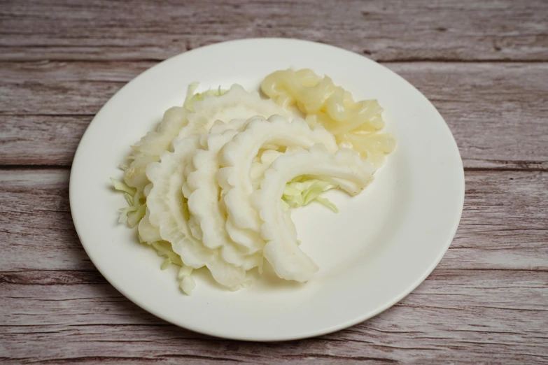 chopped vegetable on a plate on a wood table