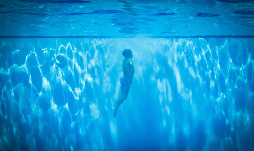 the woman is floating in the water on a clear day