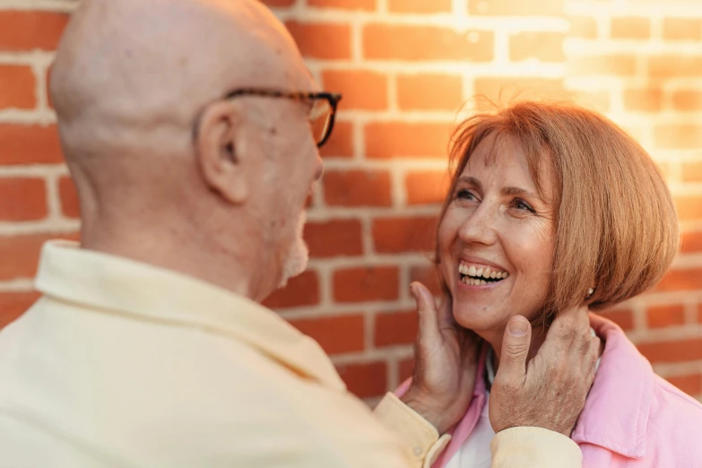 a woman smiling as she holds her husband's neck