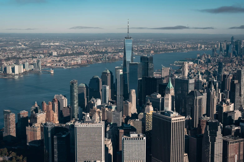 the manhattan city skyline with a river in the foreground