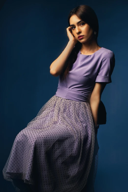 a beautiful young woman in a short dress posing