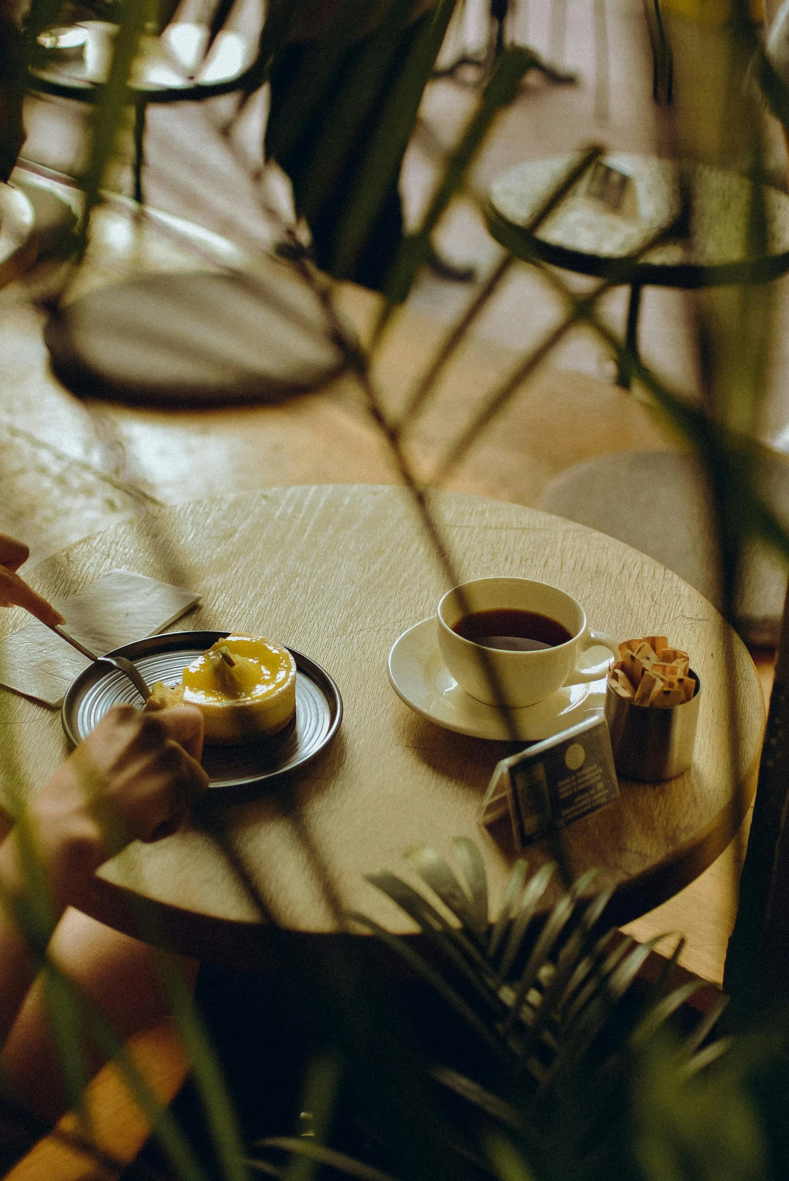 someone's hand reaches into a small plate with food on it