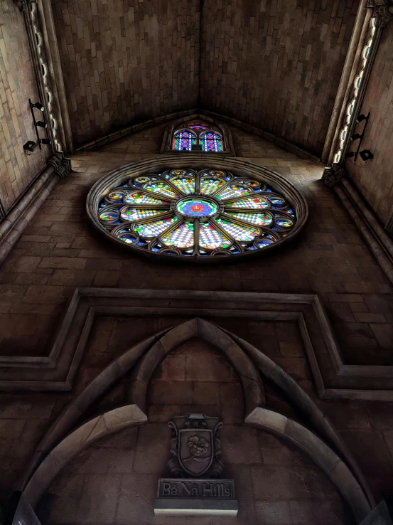 a stained glass window is above the alter