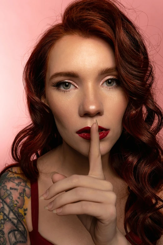 a woman posing for a po with a finger on her lips