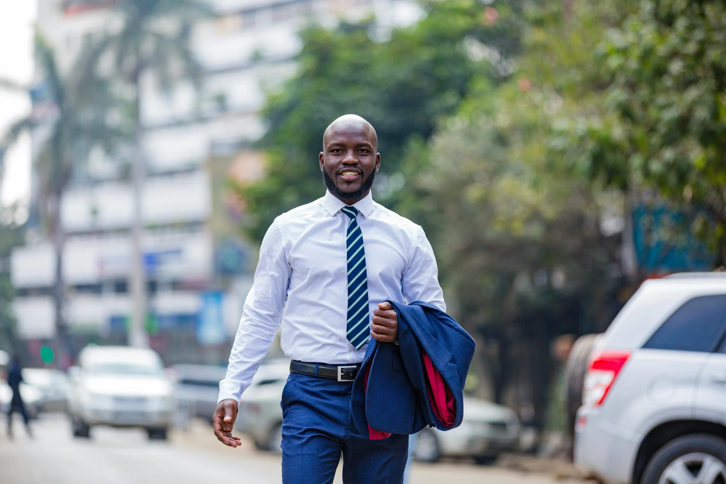 man walking down the street carrying a bag