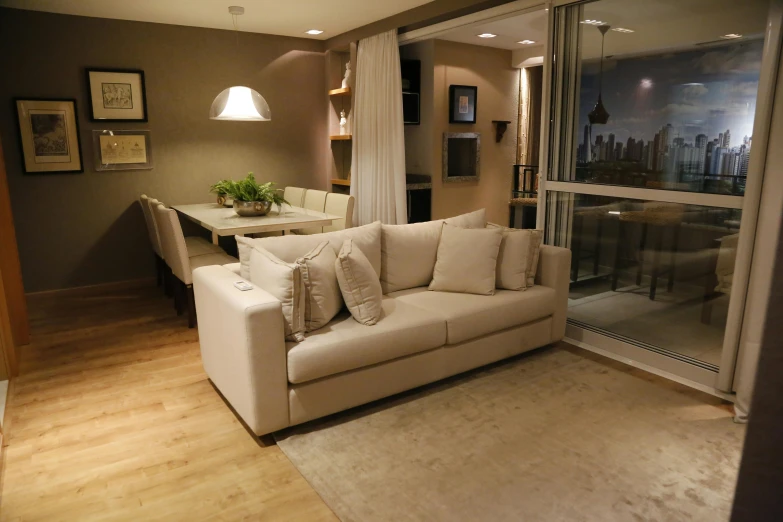 a couch sitting in a living room with curtains