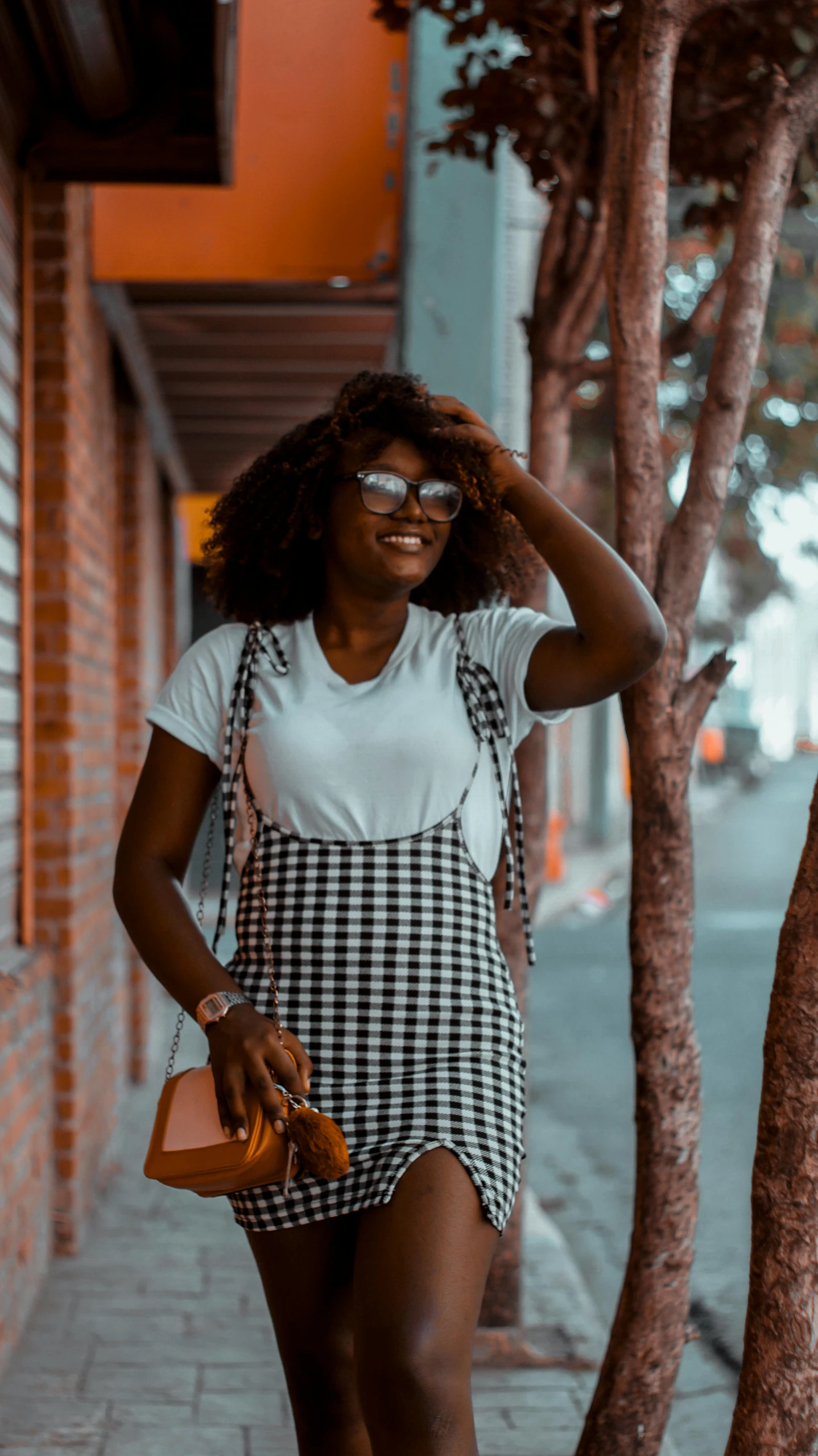 a woman with a plaid apron holding her purse