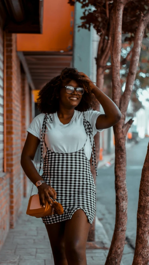 a woman with a plaid apron holding her purse