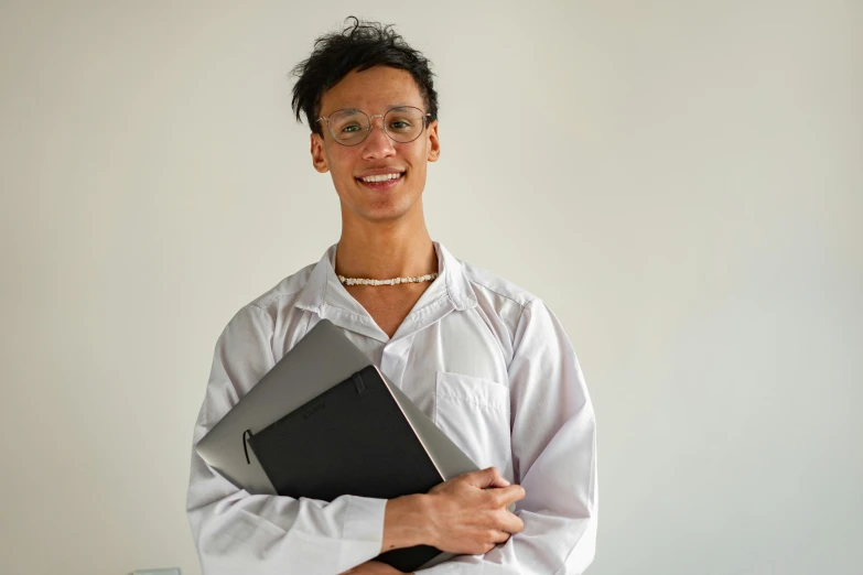 a man with glasses and a book in his lap