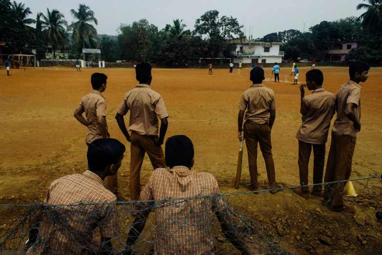 a group of people are playing baseball in a field