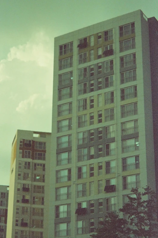 a large building sits with a cloudy sky in the background