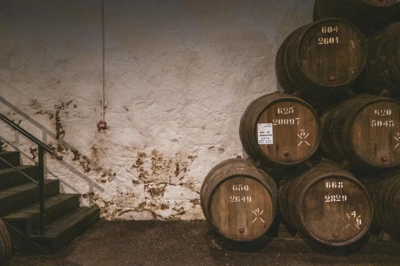 three stacks of wine barrels in a cellar