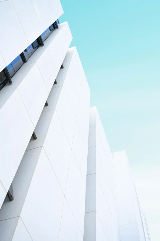 a airplane flying in the air near the top of a building