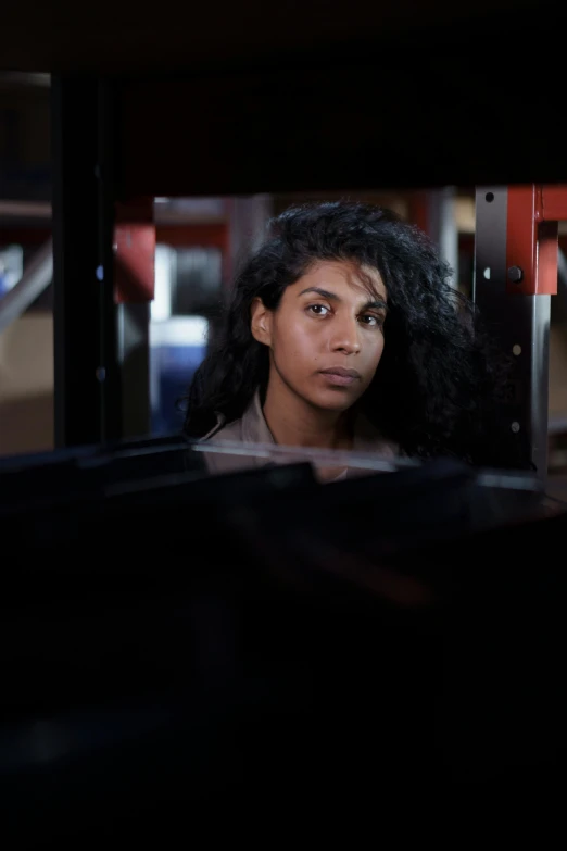 a woman stares through a window on a bus
