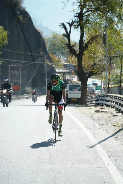 man riding bicycle down the middle of an empty street