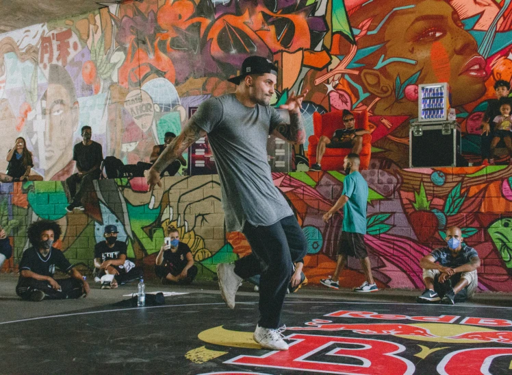 a man is dancing on the floor in front of people