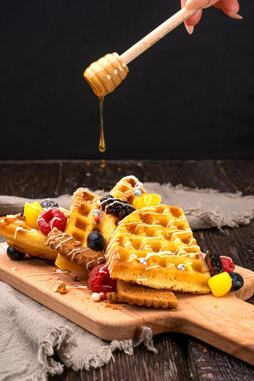 some waffles with fruit being put over them