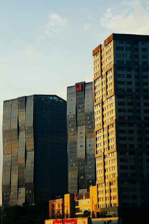 a line of skyscrs and a airplane flying past them