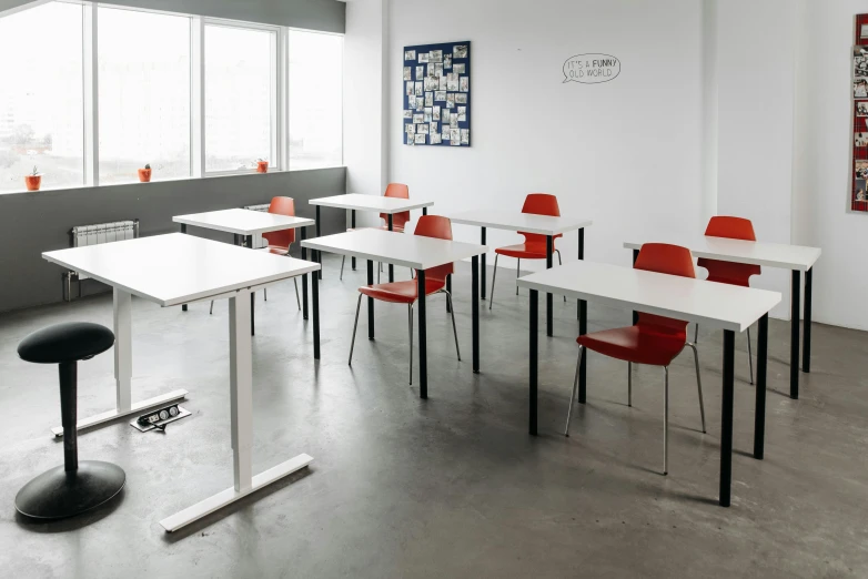 a table, with several chairs and one is red