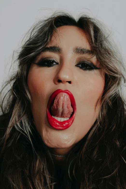 a beautiful woman with her tongue out showing the inside