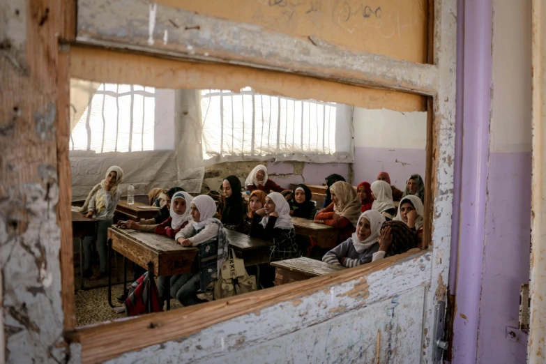 a large group of people sitting in front of a classroom