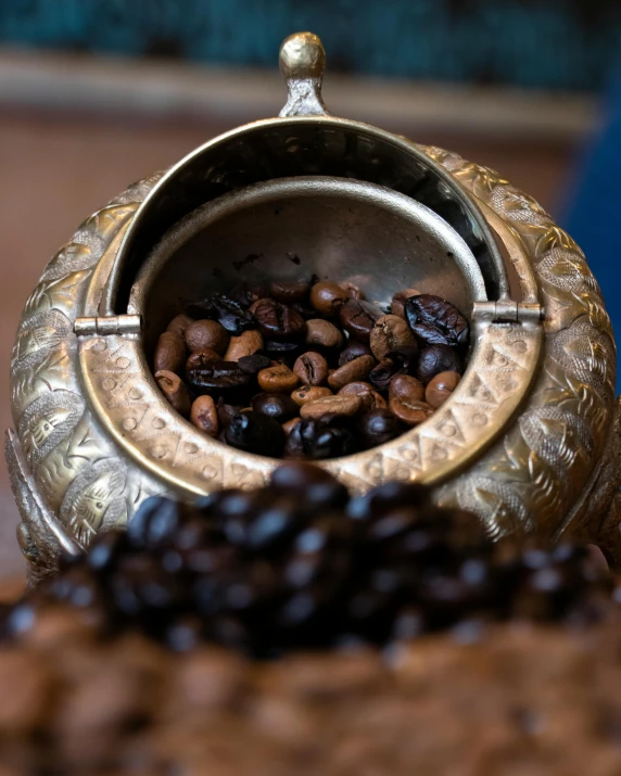 a coffee grinder full of beans and coffee beans