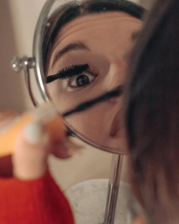 woman looking through a magnifying glass with a reflection